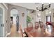 Spacious dining area showcases wood floors, chandelier, and staircase with white railing at 8800 Las Olivas Ave, Las Vegas, NV 89147