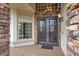 Elegant front entrance featuring double doors, stone accents, and a welcoming covered porch at 8800 Las Olivas Ave, Las Vegas, NV 89147