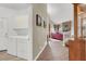 View of hallway leading to the living room with hardwood floors and white trim at 8800 Las Olivas Ave, Las Vegas, NV 89147