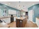 Bright kitchen with white cabinets, a center island, granite countertops, and stainless steel appliances at 8800 Las Olivas Ave, Las Vegas, NV 89147