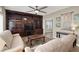 Cozy living room features custom built-ins, ceiling fan, and neutral decor at 8800 Las Olivas Ave, Las Vegas, NV 89147