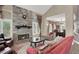 Comfortable living room featuring a stone fireplace, large windows, and stylish furnishings at 8800 Las Olivas Ave, Las Vegas, NV 89147