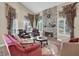 Cozy living room showcasing a stone fireplace, plush seating, and ample natural light at 8800 Las Olivas Ave, Las Vegas, NV 89147