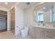 Modern bathroom featuring stylish vanity, elegant mirror, and a glass-enclosed shower with a view to the patio at 9101 Alta Dr # 207, Las Vegas, NV 89145