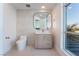 Modern bathroom with sleek vanity, round mirror, and soft lighting providing a serene and sophisticated design at 9101 Alta Dr # 207, Las Vegas, NV 89145