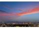 Panoramic city view at dusk with colorful clouds painting the sky in hues of pink and orange at 9101 Alta Dr # 207, Las Vegas, NV 89145