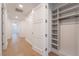 Hallway with wood flooring, white doors, and a built-in gray shelving unit at 9101 Alta Dr # 207, Las Vegas, NV 89145