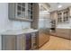 Kitchen featuring stainless steel Viking fridge, custom gray cabinets, marble countertops, and wood flooring at 9101 Alta Dr # 207, Las Vegas, NV 89145