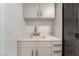 Beautiful laundry room featuring custom cabinets, quartz countertops, and modern, stylish fixtures at 9101 Alta Dr # 207, Las Vegas, NV 89145