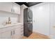 Modern laundry room with sleek cabinets, quartz countertops, and a high-efficiency washer and dryer unit at 9101 Alta Dr # 207, Las Vegas, NV 89145