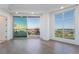 Living room with large windows and patio access, featuring sleek hardwood floors and bright, neutral tones at 9101 Alta Dr # 207, Las Vegas, NV 89145