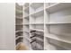 Walk-in pantry with ample shelving and black wire storage baskets for optimal organization at 9101 Alta Dr # 207, Las Vegas, NV 89145