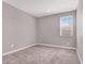 Neutral bedroom with plush carpeting, light gray walls, and a window with bright natural light at 9330 Brookmont Ave, Las Vegas, NV 89149