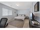 Well-lit bedroom with a large window, a comfortable bed, and a minimalist decor at 10525 Gibbous Moon Dr, Las Vegas, NV 89129