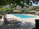 Relaxing community pool area with lounge chairs and shaded seating at 10525 Gibbous Moon Dr, Las Vegas, NV 89129