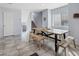 Bright dining room with a large wooden table, benches, and tile flooring at 10525 Gibbous Moon Dr, Las Vegas, NV 89129