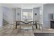 Bright dining area featuring a large wooden table and benches with tile flooring at 10525 Gibbous Moon Dr, Las Vegas, NV 89129