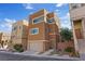 Modern three-story home boasting neutral paint, a two-car garage and well-maintained landscaping at 10525 Gibbous Moon Dr, Las Vegas, NV 89129