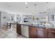 Kitchen featuring dark cabinetry, granite countertops, stainless steel appliances, and an open floor plan at 10525 Gibbous Moon Dr, Las Vegas, NV 89129