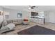 Open concept living room featuring a large sectional sofa, ceiling fan and view of the kitchen at 10525 Gibbous Moon Dr, Las Vegas, NV 89129