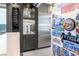 Modern bar area featuring stainless steel refrigerator, wine cooler, and glassware display at 10605 Harvest Green Way, Las Vegas, NV 89135