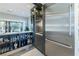 Bright bar area featuring stainless steel refrigerator and stocked bar shelves at 10605 Harvest Green Way, Las Vegas, NV 89135