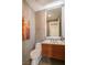 Modern powder room with stylish vanity, wood accents, and marble-look walls at 10605 Harvest Green Way, Las Vegas, NV 89135