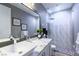 Modern bathroom with a decorative stone shower, a marble countertop, and contemporary fixtures at 10605 Harvest Green Way, Las Vegas, NV 89135