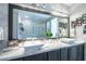 Upscale bathroom features a marble countertop, dual vessel sinks, and a large mirror reflecting a luxurious shower at 10605 Harvest Green Way, Las Vegas, NV 89135