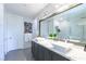 Contemporary bathroom boasts dual vessel sinks, a marble countertop, and a large mirror reflecting the shower at 10605 Harvest Green Way, Las Vegas, NV 89135