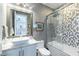 Modern bathroom featuring sleek vanity, square sink, and decorative tile shower-tub combo at 10605 Harvest Green Way, Las Vegas, NV 89135