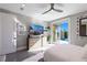 Bright bedroom with a view of the pool, featuring a ceiling fan and modern dresser with decor at 10605 Harvest Green Way, Las Vegas, NV 89135