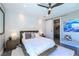 Modern bedroom with textured wall, king bed, ceiling fan, and ensuite bathroom with sliding door at 10605 Harvest Green Way, Las Vegas, NV 89135