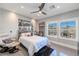 Bright bedroom with decorative windows, ceiling fan, modern furnishings, and unique black and white photography at 10605 Harvest Green Way, Las Vegas, NV 89135