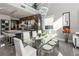 Contemporary dining area with glass table, modern lighting, and adjacent kitchen with bar seating at 10605 Harvest Green Way, Las Vegas, NV 89135