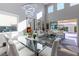 Bright, airy dining room with glass table and view to the outdoor patio at 10605 Harvest Green Way, Las Vegas, NV 89135