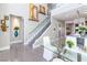 Bright dining room featuring a modern staircase, and views of the kitchen with elegant decor and recessed lighting at 10605 Harvest Green Way, Las Vegas, NV 89135