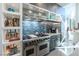 Gourmet kitchen featuring stainless steel appliances, custom cabinets, and a blue tile backsplash at 10605 Harvest Green Way, Las Vegas, NV 89135