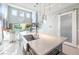 Bright kitchen island with quartz countertop, stainless steel sink, and open layout to living area at 10605 Harvest Green Way, Las Vegas, NV 89135