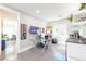 Home office featuring a modern glass desk, built-in shelves, and ample natural light at 10605 Harvest Green Way, Las Vegas, NV 89135