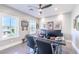 Well-lit home office featuring a modern desk, multiple monitors, and views from two windows at 10605 Harvest Green Way, Las Vegas, NV 89135