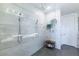 Modern tiled shower featuring both rainfall and handheld shower heads, alongside a convenient bench at 10605 Harvest Green Way, Las Vegas, NV 89135