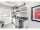 Wet bar area featuring white cabinetry, floating shelves, and a wine fridge at 10605 Harvest Green Way, Las Vegas, NV 89135