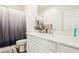 Bright bathroom with a clean white vanity, large mirror, modern fixtures, and a shower-tub combination at 10801 Far Country Ave, Las Vegas, NV 89129