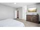 Bedroom featuring neutral tones, plush carpeting, and a dresser with a TV at 10801 Far Country Ave, Las Vegas, NV 89129