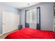 Bedroom with a red bed, window, closet, and modern decor creates a relaxing space at 10801 Far Country Ave, Las Vegas, NV 89129