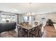 Sunlit dining area featuring a TV, sliding glass doors, and a cozy seating area nearby at 10801 Far Country Ave, Las Vegas, NV 89129