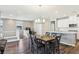 Open-concept dining room with views of the kitchen, upstairs landing, and stylish chandelier at 10801 Far Country Ave, Las Vegas, NV 89129