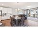 Dining area adjacent to the kitchen with a large sliding glass door to backyard, and a comfy sofa at 10801 Far Country Ave, Las Vegas, NV 89129