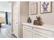 Hallway features wood floors, a built-in cabinet with decor, and access to other parts of the home at 10801 Far Country Ave, Las Vegas, NV 89129